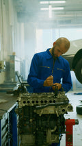 KFZ-Mechaniker bei Arbeiten an einem Motor in der Werkstatt